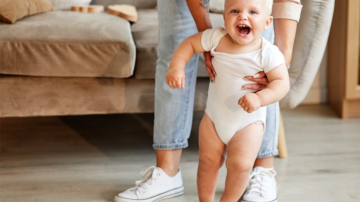 A baby working toward its first steps.