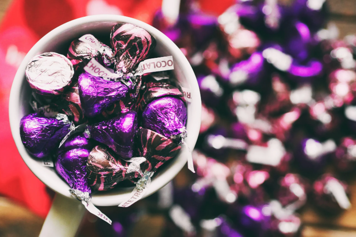 A cup full of chocolate kisses.