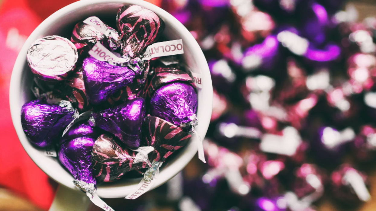 A cup full of chocolate kisses.