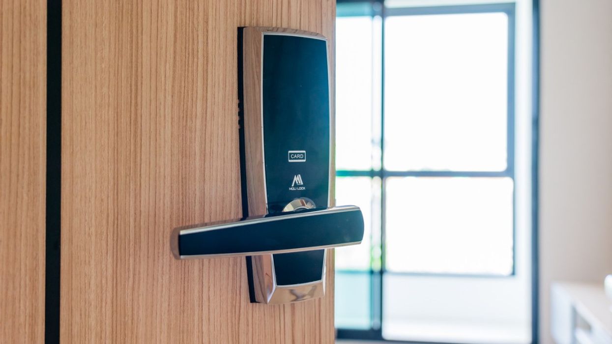 A hotel room door, ajar.