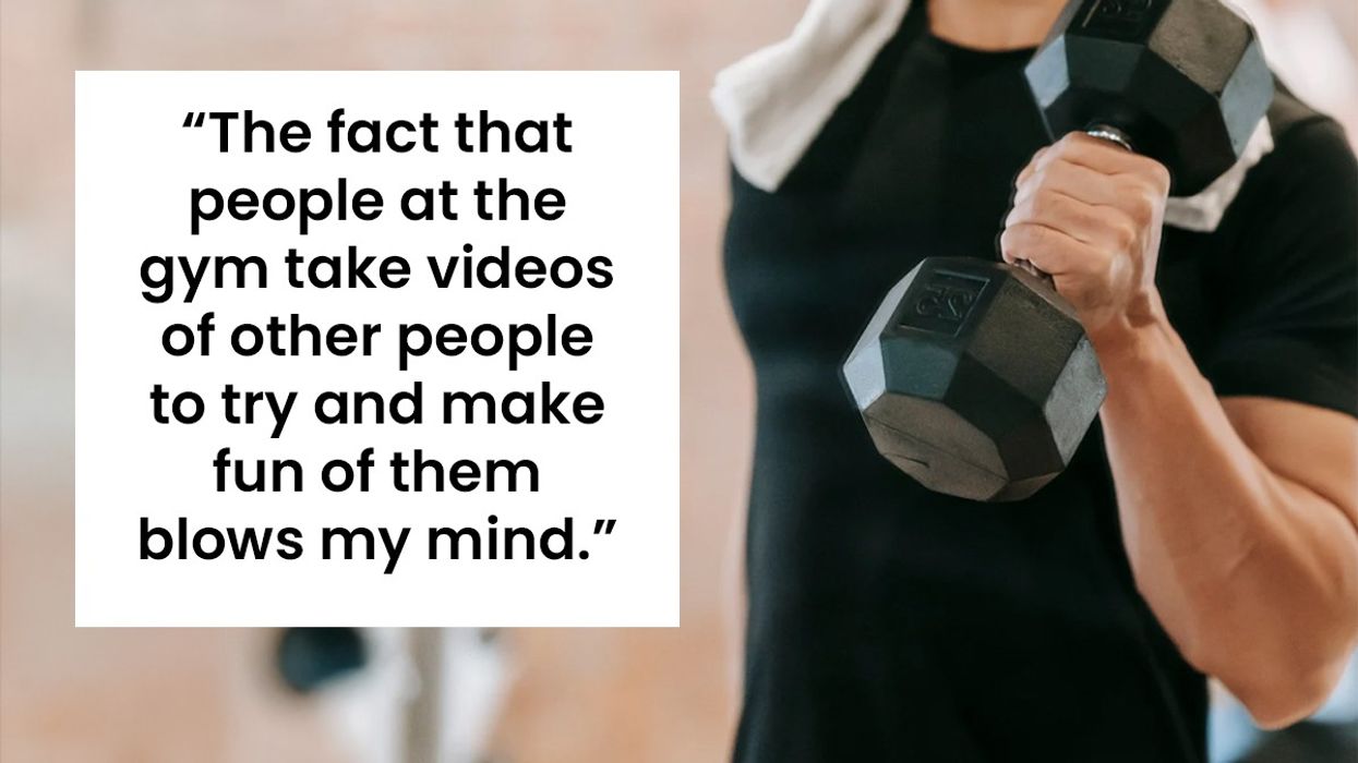 A man at the gym lifting a weight.