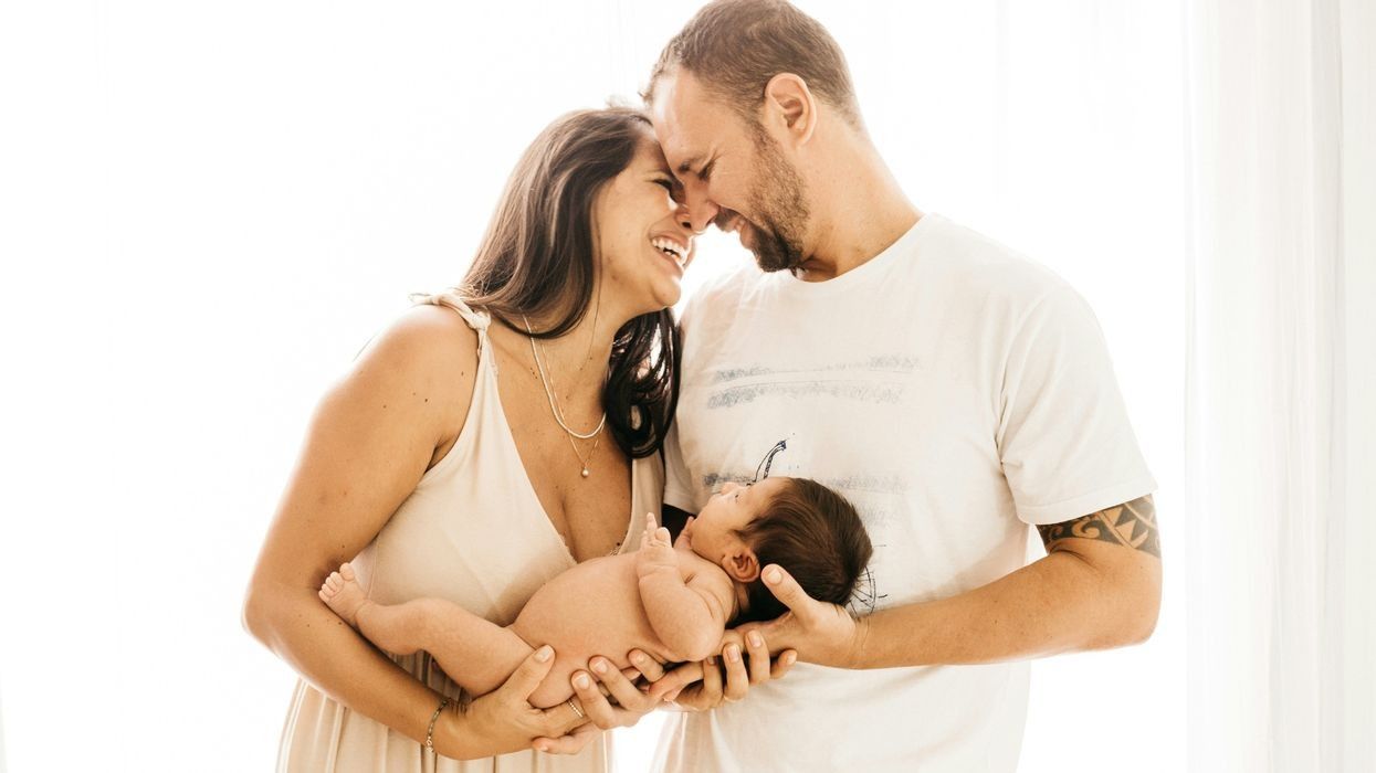 A new family, mother, father, and baby.