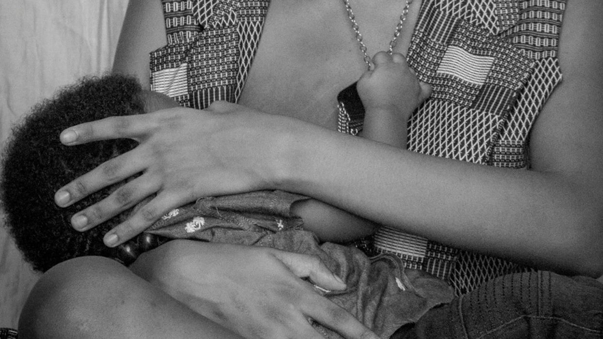 A new mother breastfeeds her young son.