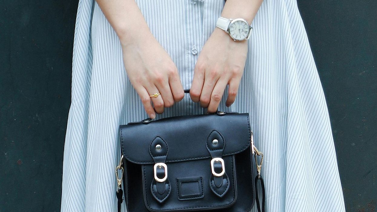 A woman holding a purse.