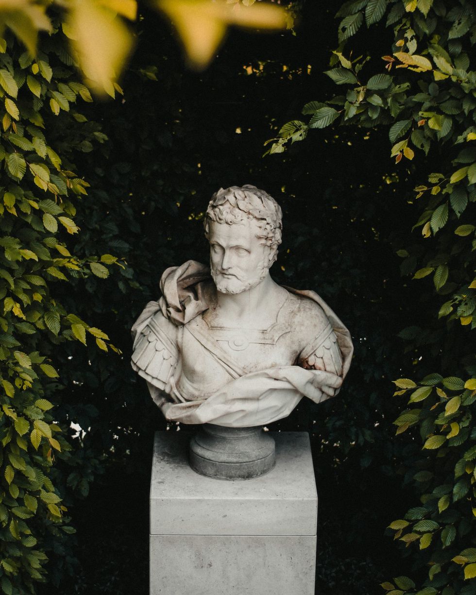 bust of a statue of a man placed on top of a cement block