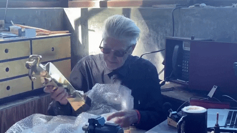 David Lynch unwrapping an award