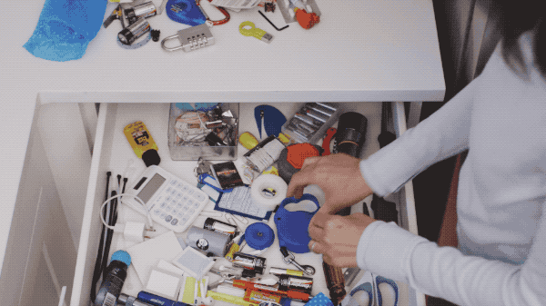 gif of woman straightening cluttered drawer
