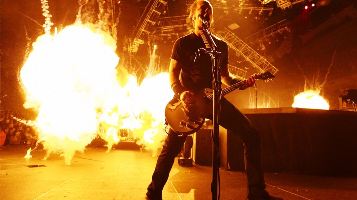 James Hetfield with Metallica performs in front of pyrotechnics.