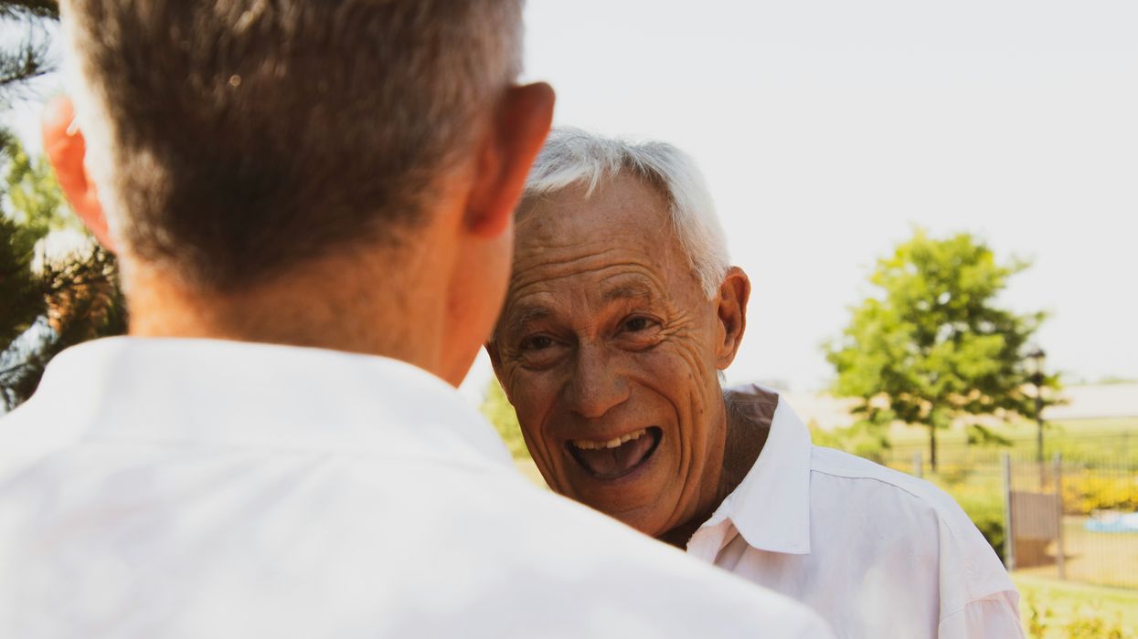 man facing elderly man