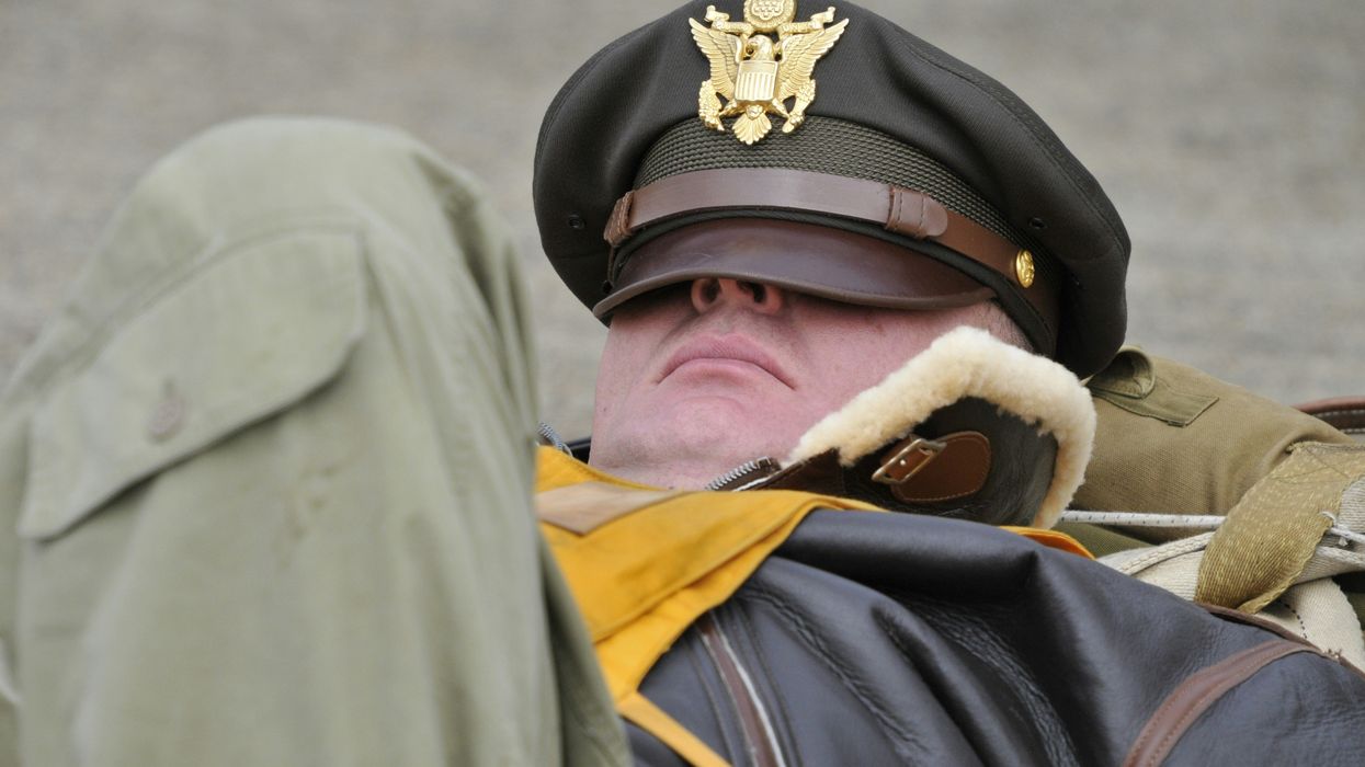 man sleeping with hat on face