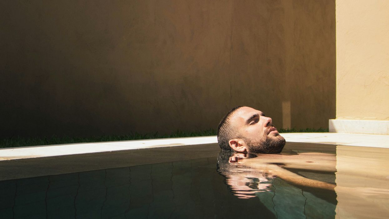 Man soaking in a large pool or tub
