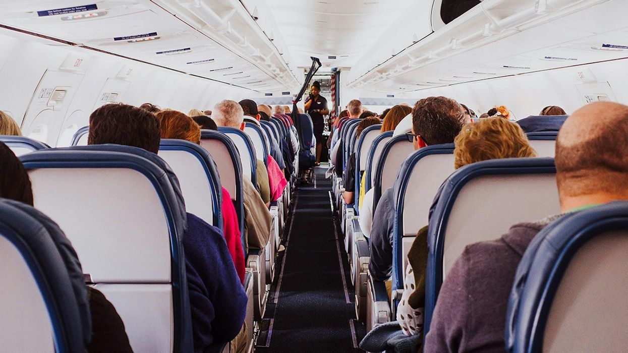 Passengers waiting on an airplane.