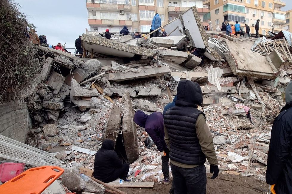 People stuggle to lend aid in the aftermath of the massive earthquake.