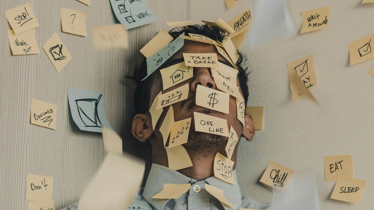 Person covered in sticky notes, overwhelmed