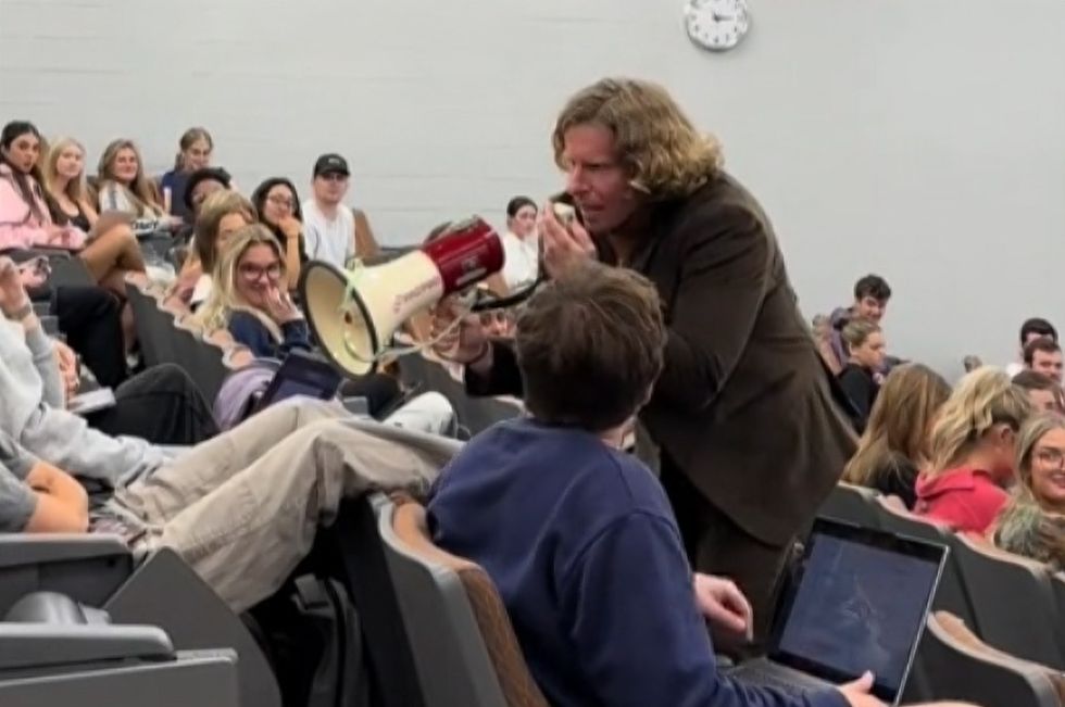 Professor Pittman prepares his bullhorn to wake a dozing student.