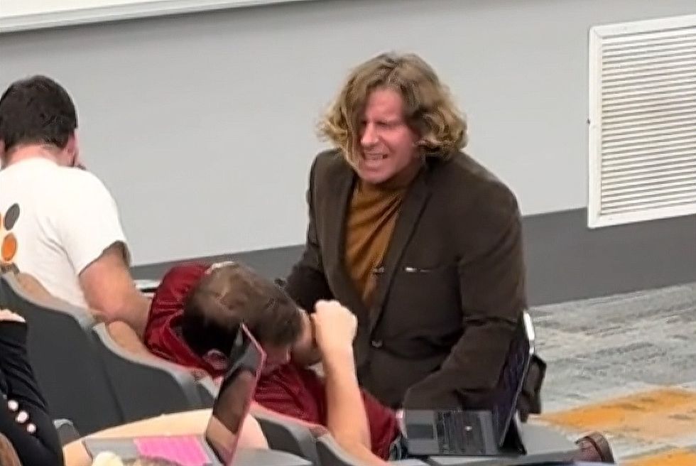 Professor Pittman uses his considerable talents to wake a dozing student.