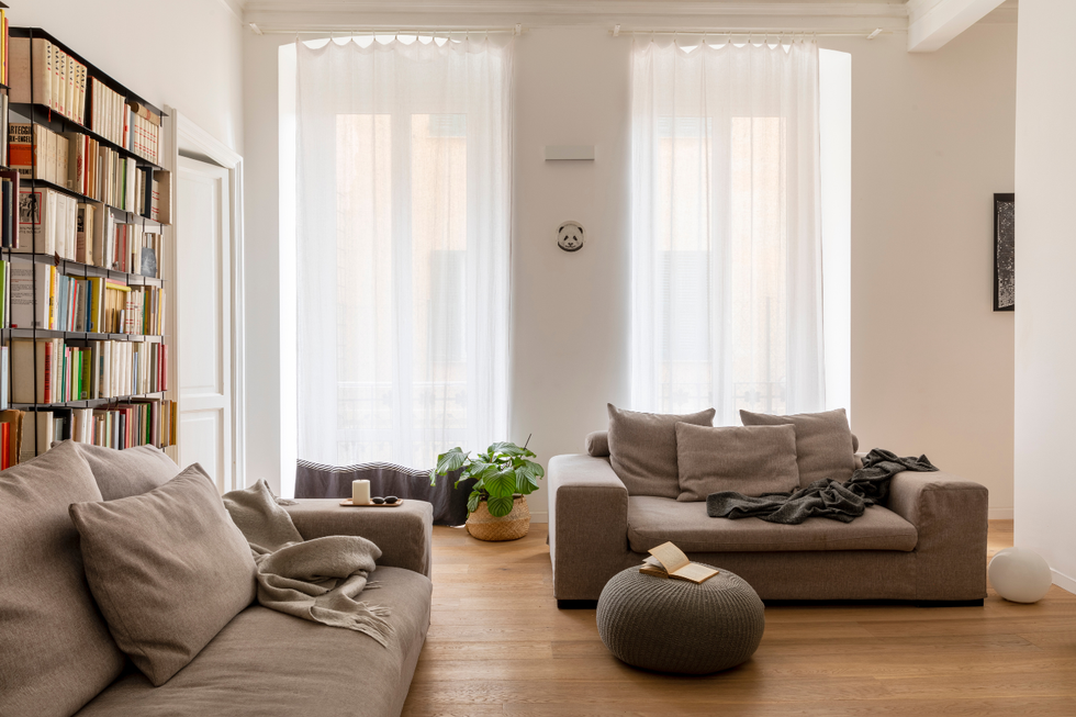 Spacious room with long, flowing curtains